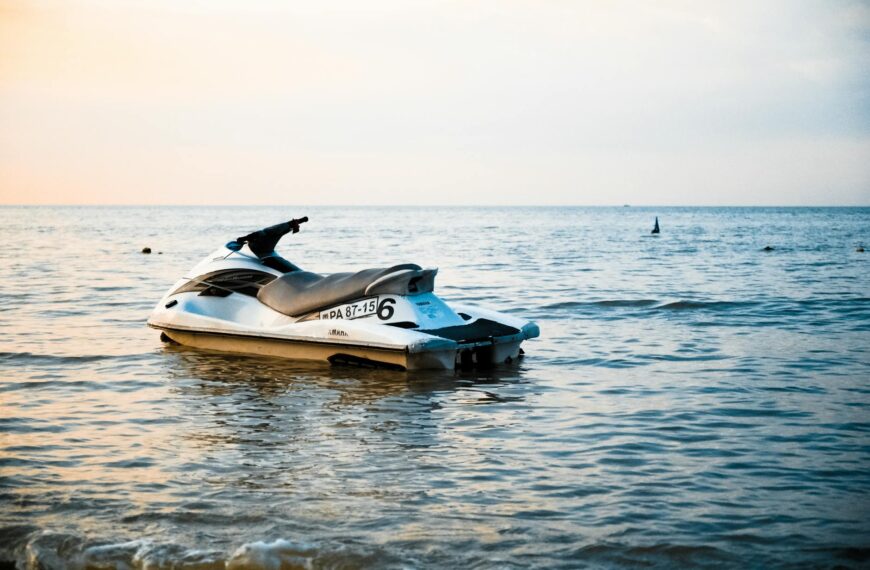 white and black personal watercraft on body of water