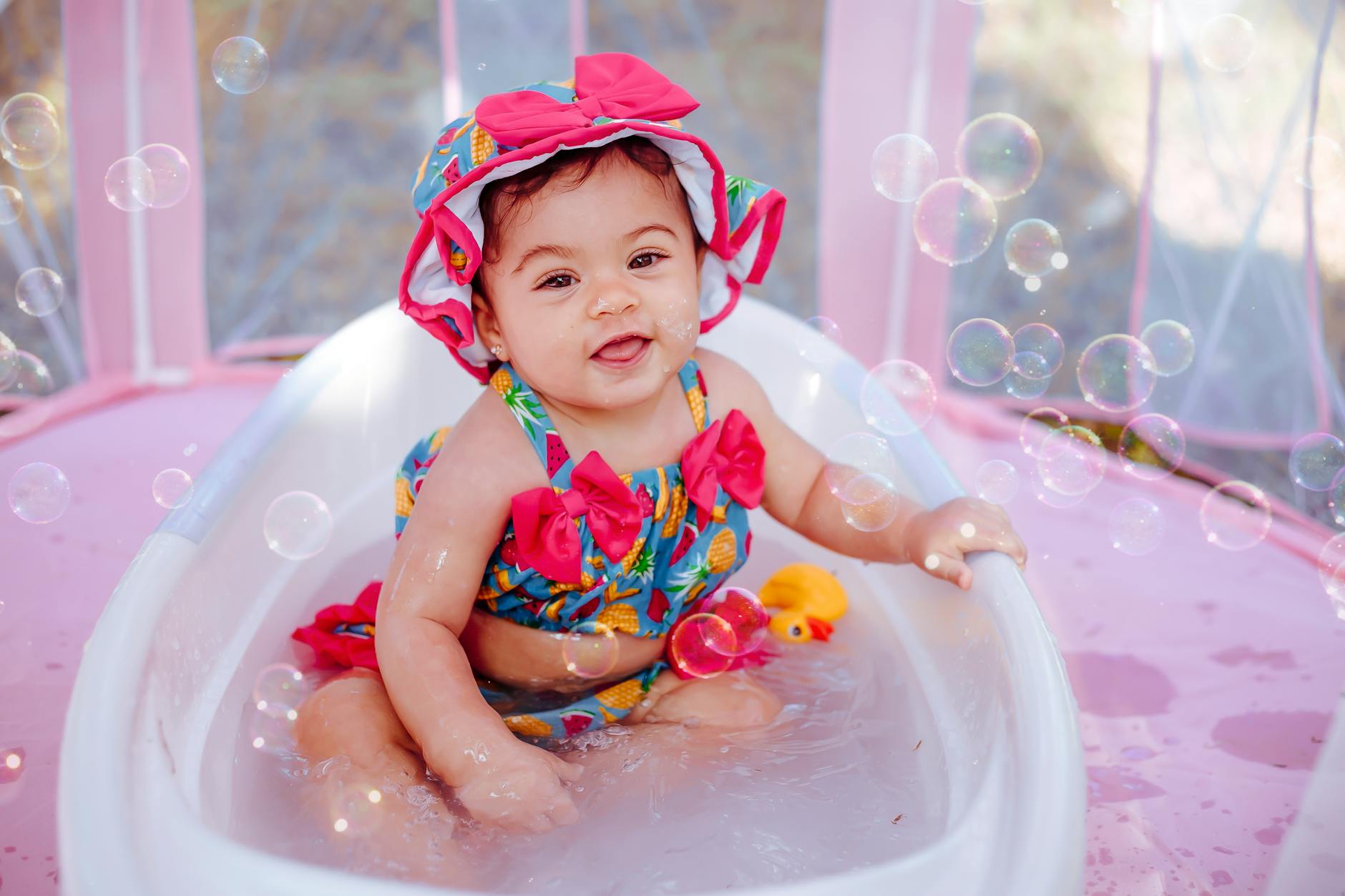 girl in bath among soap bubbles