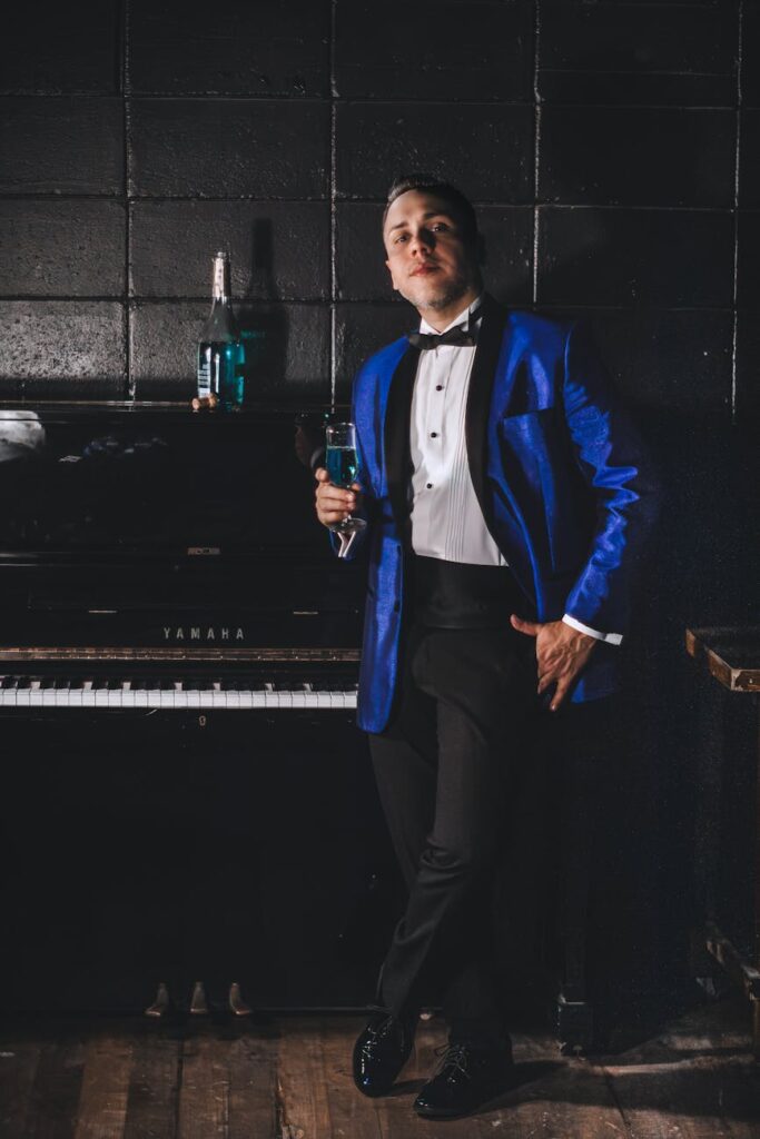 elegant man in tuxedo holding champagne glass