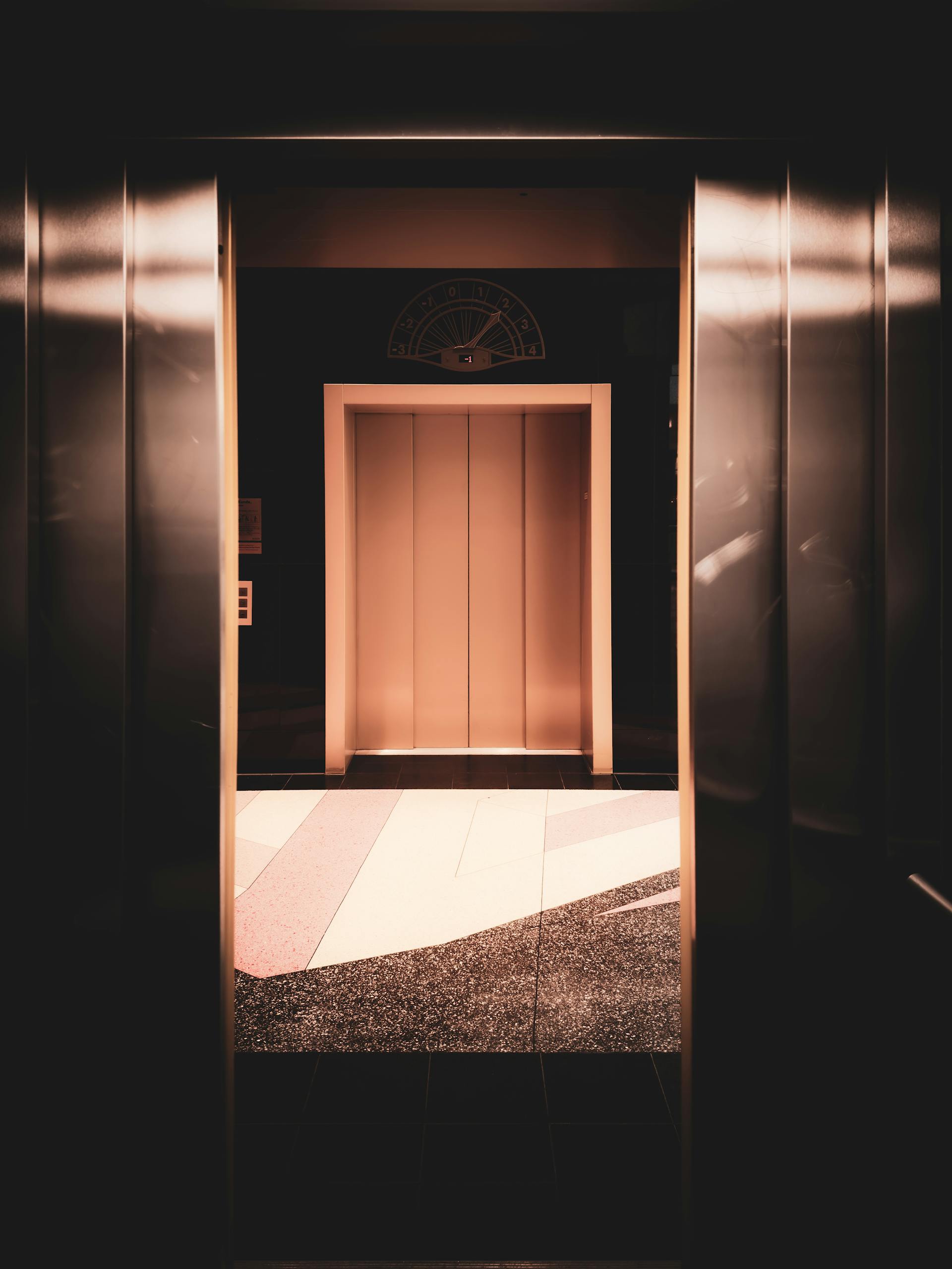 A view of a modern elevator interior with warm lighting in Berlin, Germany.