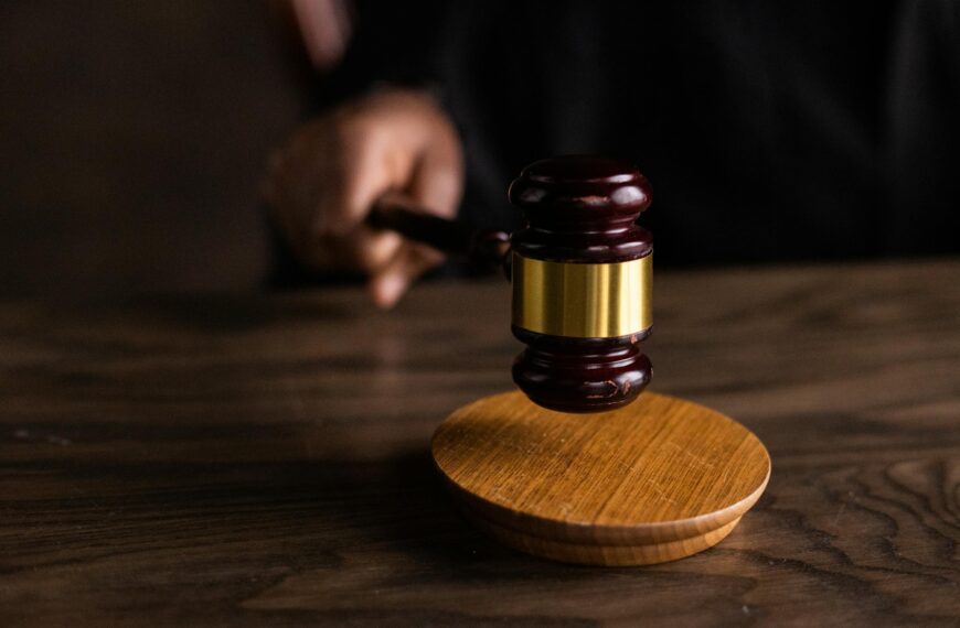 A gavel striking a sound block, symbolizing justice and legal authority in a courtroom setting.