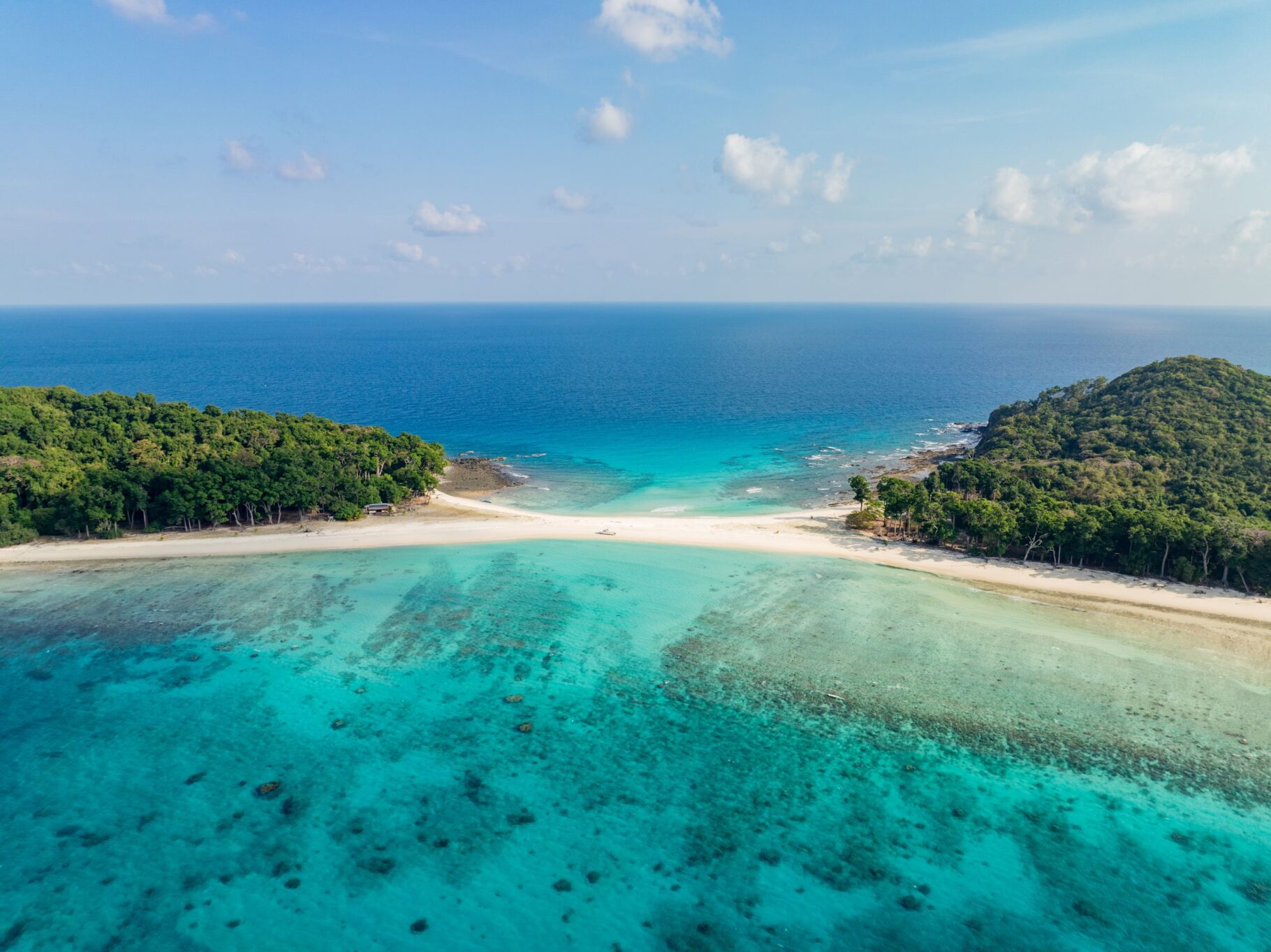 Stunning aerial view of Cinque Island's pristine white sand beaches and turquoise waters in India.